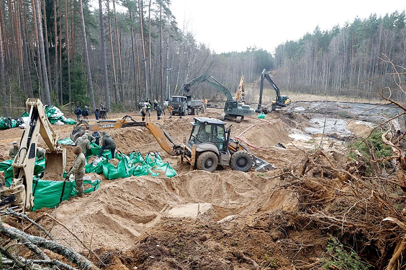 Military personnel work at the site of a rescue operation for missing US soldiers at Pabrade training ground, in Lithuania, on March 28, 2025. Lithuanian Defense Minister Dovile Sakaliene said that "all scenarios" were still being considered regarding the fate of four American soldiers who went missing during an exercise in the east of the country, stressing that their search continued under difficult conditions. (Photo by Petras Malukas / AFP) (Photo by PETRAS MALUKAS/AFP via Getty Images)