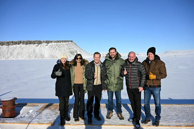 PITUFFIK, GREENLAND - MARCH 28: US Vice President JD Vance (C) poses with Second Lady Usha Vance (2nd L), National Security Advisor Mike Waltz (3rd L), his wife , former homeland security advisor, Julia Nesheiwat (L) and Secretary of Energy Chris Wright (R) as they tour the US military's Pituffik Space Base on March 28, 2025 in Pituffik, Greenland. The itinerary for the visit was scaled back after a plan for a more extensive trip drew criticism from officials in Greenland and Denmark, which controls foreign and defence policy of the semiautonomous territory. (Photo by Jim Watson - Pool / Getty Images)