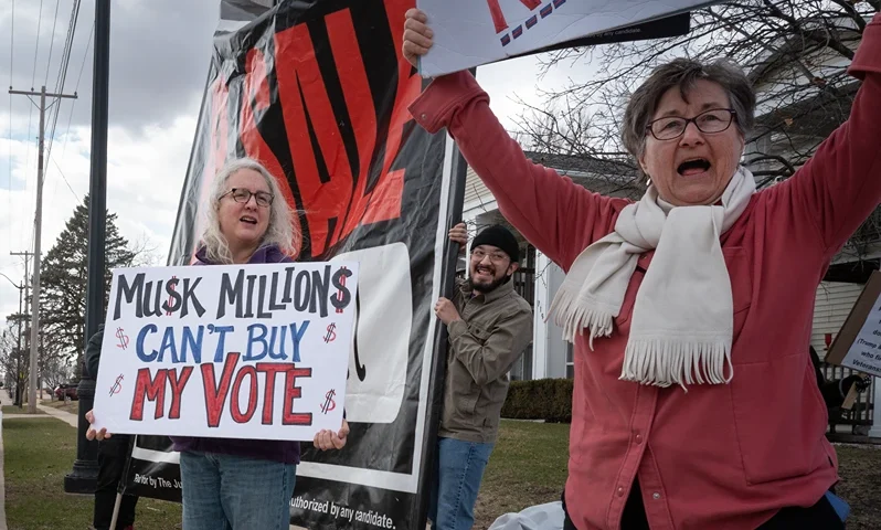 JEFFERSON, WISCONSIN - MARCH 25: Demonstrators protest outside of an event hosted by Circuit Court Judge Brad Schimel, candidate for the Wisconsin Supreme Court, on March 25, 2025 in Jefferson, Wisconsin. Schimel, who has been endorsed by President Donald Trump and financially supported by billionaire businessman Elon Musk, is running against Dane County Circuit Court Judge Susan Crawford. (Photo by Scott Olson/Getty Images)