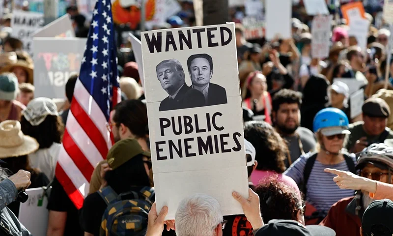 LOS ANGELES, CALIFORNIA - APRIL 05: Protestors demonstrate at a 'Hands Off!' protest against the Trump administration on April 5, 2025 in Los Angeles, California. Protests against Trump administration policies and Elon Musk's Department of Government Efficiency (DOGE) are being held nationwide in what organizers are calling a National Day of Action. (Photo by Mario Tama/Getty Images)