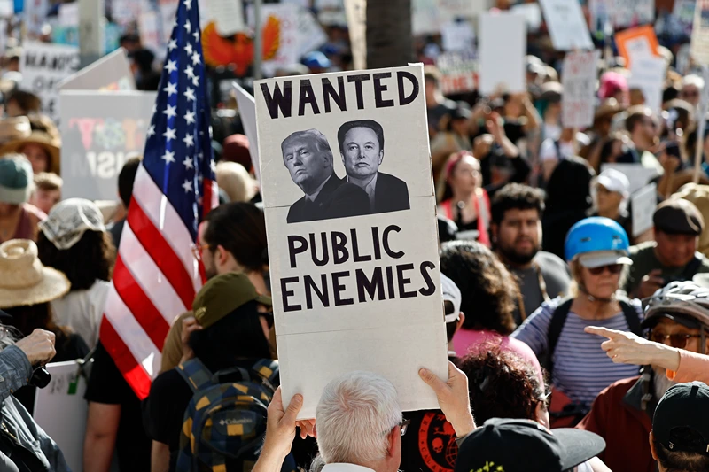 LOS ANGELES, CALIFORNIA - APRIL 05: Protestors demonstrate at a 'Hands Off!' protest against the Trump administration on April 5, 2025 in Los Angeles, California. Protests against Trump administration policies and Elon Musk's Department of Government Efficiency (DOGE) are being held nationwide in what organizers are calling a National Day of Action. (Photo by Mario Tama/Getty Images)