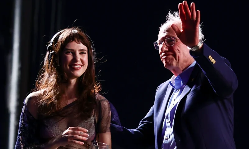 INDIO, CALIFORNIA - APRIL 12: (FOR EDITORIAL USE ONLY) (L-R) Clairo and Bernie Sanders speak onstage at Outdoor Theatre during the 2025 Coachella Valley Music and Arts Festival at Empire Polo Club on April 12, 2025 in Indio, California. (Photo by Emma McIntyre/Getty Images for Coachella)