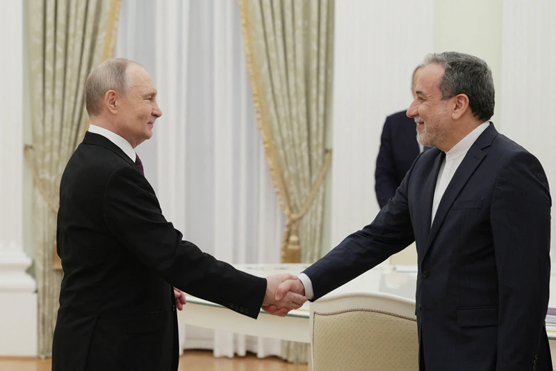 TOPSHOT - In this pool photograph distributed by the Russian state agency Sputnik, Russia's President Vladimir Putin shakes hands with Iran's Foreign Minister Abbas Araghchi during a meeting at the Kremlin in Moscow on April 17, 2025. (Photo by Gavriil Grigorov / POOL / AFP) (Photo by GAVRIIL GRIGOROV/POOL/AFP via Getty Images)