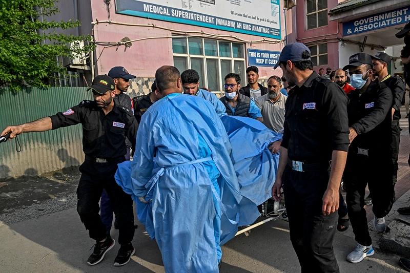 Paramedics and police personnel carry an injured tourist at a hospital in Anantnag, south of Srinagar, on April 22, 2025, following an attack. Gunmen in Indian-administered Kashmir opened fire on a group of tourists on April 22, with the chief minister saying the "inhuman" attack was one of the worst targeting civilians for years. At least five people were killed, a senior politician in the Himalayan region said. (Photo by Tauseef MUSTAFA / AFP) (Photo by TAUSEEF MUSTAFA/AFP via Getty Images)