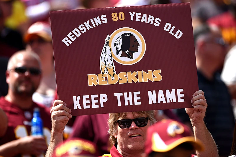 LANDOVER, MD - SEPTEMBER 14: A Washington Redskins fan holds up a sign to keep the Redskins name before they play the Jacksonville Jaguars at FedExField on September 14, 2014 in Landover, Maryland. The Washington Redskins won, 41-10. (Photo by Patrick Smith/Getty Images)