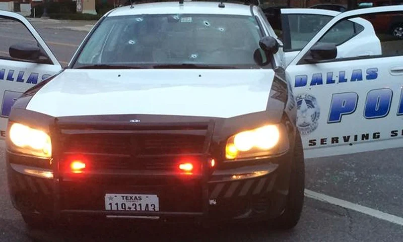 : In this handout photo provided by the Dallas Police Department bullet holes are seen in the glass windows of a police cruiser on June 13, 2015 in Dallas, Texas. A single gunman opened fire on the building early Saturday morning, reportedly unleashing multiple rounds and planting explosive devices around the station. No injuries have been reported. (Photo by Dallas Police Department via Getty Images)