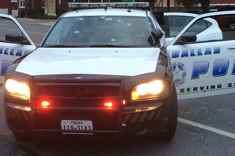 : In this handout photo provided by the Dallas Police Department bullet holes are seen in the glass windows of a police cruiser on June 13, 2015 in Dallas, Texas. A single gunman opened fire on the building early Saturday morning, reportedly unleashing multiple rounds and planting explosive devices around the station. No injuries have been reported. (Photo by Dallas Police Department via Getty Images)