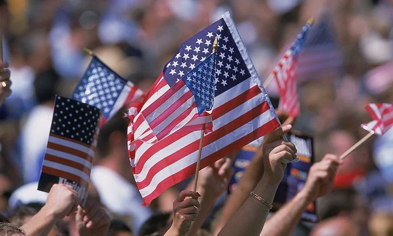 22 Sep 2001: American Flags are waved by the crowd during the game between the Ohio State Buckeyes and the California Los Angeles (UCLA) Bruins at the Rose Bowl in Pasadena, California. The Bruins defeated the Buckeyes 13-6.Mandatory Credit: Stephen Dunn /Allsport