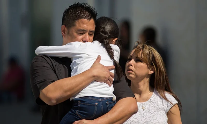 SAN BERNARDINO, CA - APRIL 10: North Park Elementary School students and parents are reunited at Cajon High School after a shooting at their school on April 10, 2017 in San Bernardino, California. In what appears to be a murder-suicide, a teacher and the shooter, her husband, both died at the scene. An 8 year old boy died later at the hospital and another child is in stable condition. (Photo by David McNew/Getty Images)