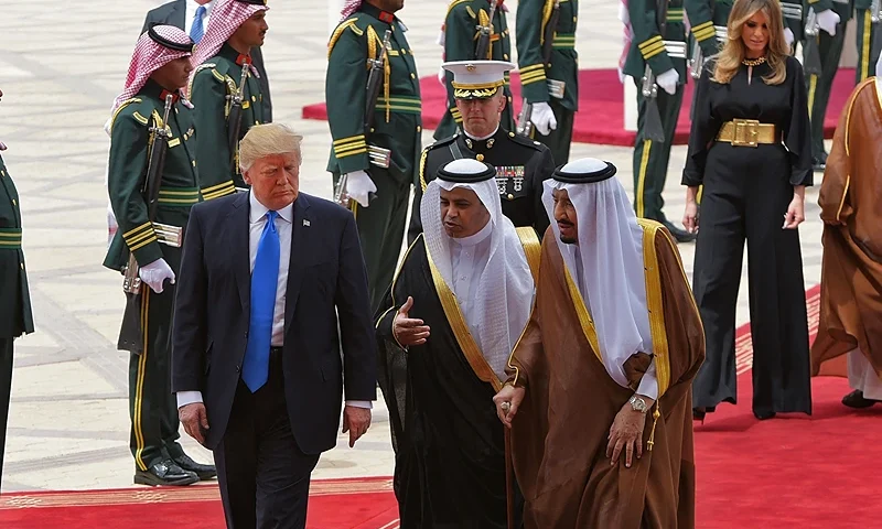 US President Donald Trump (C) is welcomed by Saudi King Salman bin Abdulaziz al-Saud (3rd-R) upon arrival at King Khalid International Airport in Riyadh on May 20, 2017, followed by First Lady Melania Trump (2nd-R). (Photo by MANDEL NGAN / AFP) (Photo by MANDEL NGAN/AFP via Getty Images)
