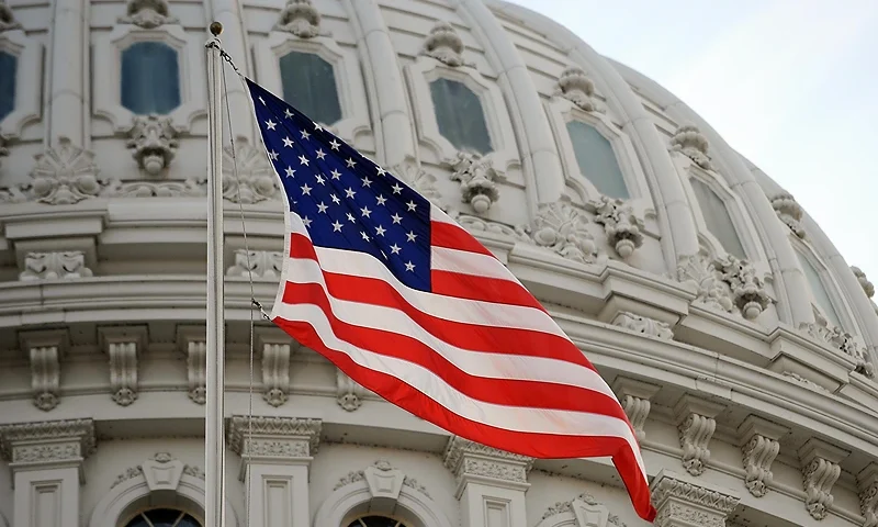The US flag flies at the US Capitol in Washington, DC, January 20, 2009. Millions of people are expected to be in the US capital to witness the swearing of Barack Obama as 44th President of the United States. AFP PHOTO/Stan HONDA (Photo credit should read STAN HONDA/AFP via Getty Images)