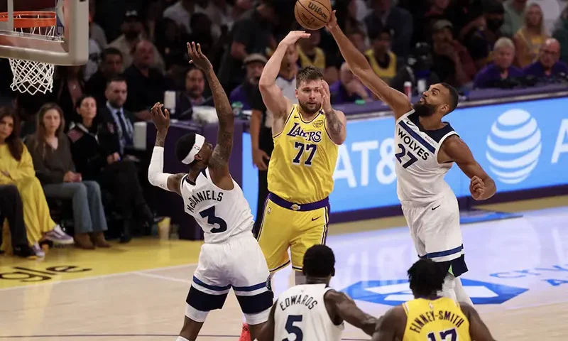 Los Angeles Lakers guard Luka Doncic (77) pass is deflected by Minnesota Timberwolves center Rudy Gobert (27) during the third quarter of game two of first round for the 2024 NBA Playoffs at Crypto.com Arena. Mandatory Credit: Kiyoshi Mio-Imagn Images