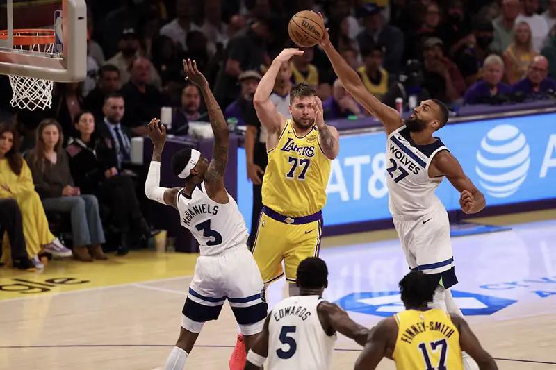 Los Angeles Lakers guard Luka Doncic (77) pass is deflected by Minnesota Timberwolves center Rudy Gobert (27) during the third quarter of game two of first round for the 2024 NBA Playoffs at Crypto.com Arena. Mandatory Credit: Kiyoshi Mio-Imagn Images