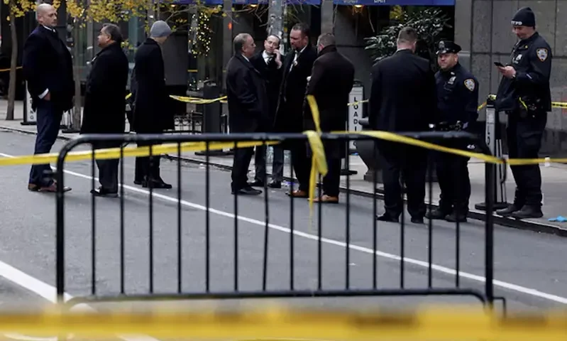 Law enforcement officers stand near the scene where the CEO of UnitedHealthcare Brian Thompson was reportedly shot and killed in Midtown Manhattan, in New York City, US, December 4, 2024.REUTERS/Shannon Stapleton/File Photo
