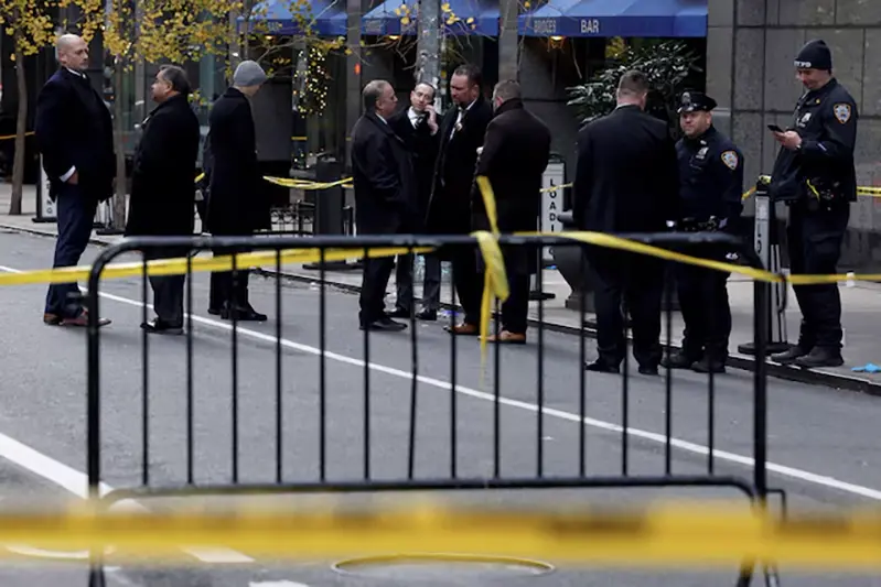 Law enforcement officers stand near the scene where the CEO of UnitedHealthcare Brian Thompson was reportedly shot and killed in Midtown Manhattan, in New York City, US, December 4, 2024.REUTERS/Shannon Stapleton/File Photo