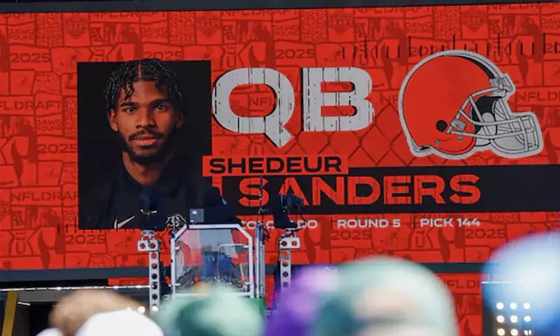 A graphic announcing Colorado quarterback Shedeur Sanders’ selection by the Cleveland Browns with the 144th overall pick is seen in the Draft Theater during the third day of the 2025 NFL Draft at Lambeau Field. Mandatory Credit: Tork Mason/USA Today Network via Imagn Images/File Photo