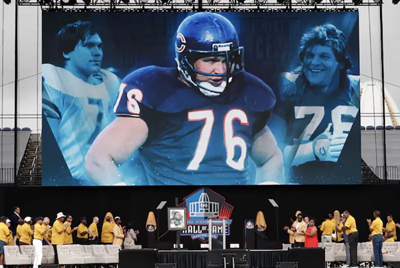 A video is played of Class of 2024 member Steve Mc Michael during his induction into the Pro Football Hall of Fame at the enshrinement ceremony at Tom Benson Hall of Fame Stadium. McMichael was unable to attend in person. Mandatory Credit: Charles LeClaire-USA TODAY Sports/File Photo