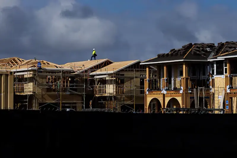 A construction worker pauses for a rest as he helps build residential homes in Irvine, California, U.S., March 28, 2025. REUTERS/Mike Blake/File Photo