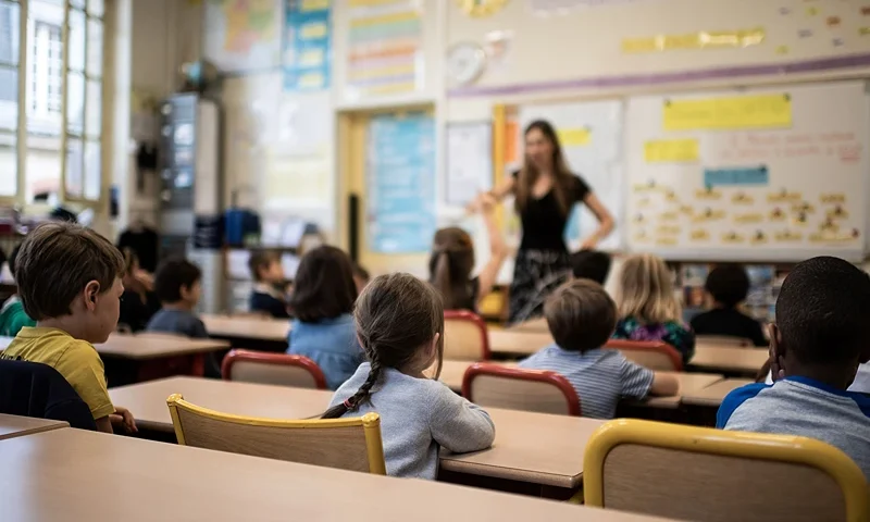 TOPSHOT - Children listen to their teacher as they sit in a classroom on the first day of the start of the school year, at the Chaptal elementary school in Paris, on September 2, 2019. - In France some 12.4 million students crossed the doors of elementary schools (6.7 million), secondary school (3.4 million) and high schools (2.3 million) on September 2, 2019. (Photo by Martin BUREAU / AFP) (Photo credit should read MARTIN BUREAU/AFP via Getty Images)