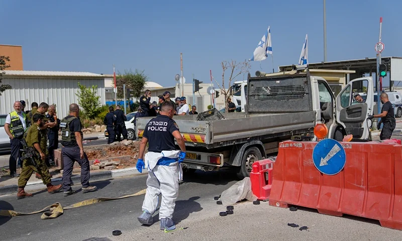 Israeli security forces inspect the scene of a Palestinian ramming attack near West Bank Maccabim checkpoint, Thursday, Aug. 31, 2023. A Palestinian driver slammed his truck into pedestrians at a busy checkpoint in the occupied West Bank on Thursday, killing one Israeli before being shot, Israeli authorities said. (AP Photo/Ohad Zwigenberg)