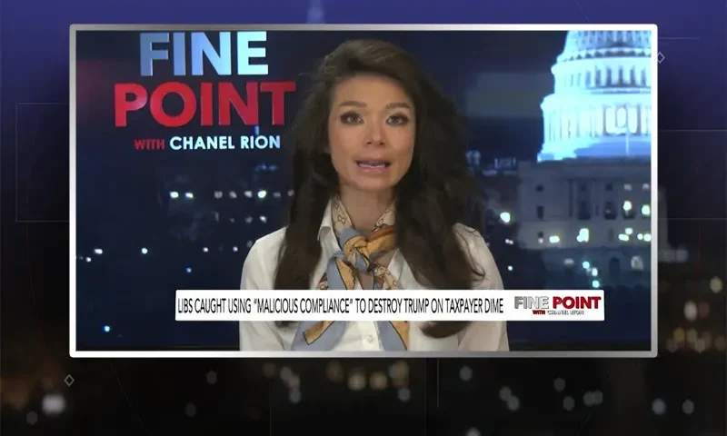 Video still of the host of Fine Point at the desk of their talk show on One America News Network.