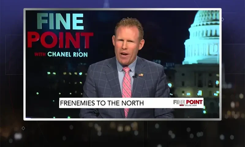 Video still of the host of Fine Point at the desk of their talk show on One America News Network.