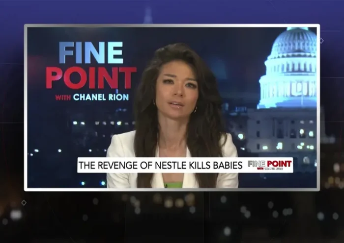 Video still of the host of Fine Point at the desk of their talk show on One America News Network.