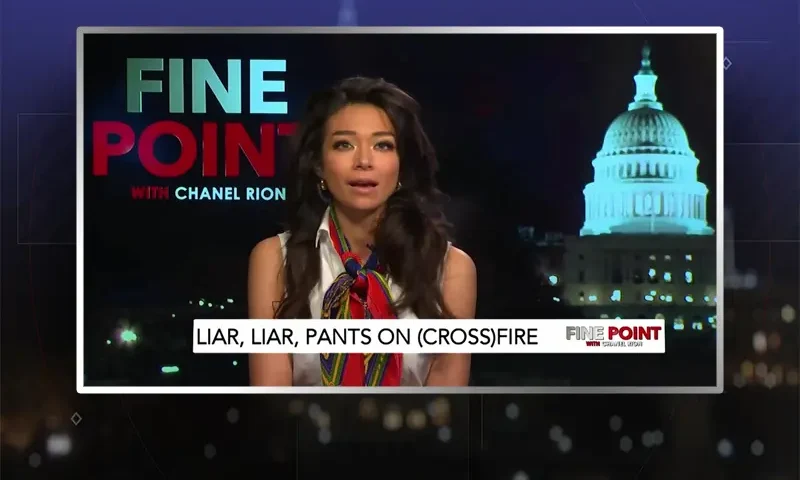 Video still of the host of Fine Point at the desk of their talk show on One America News Network.