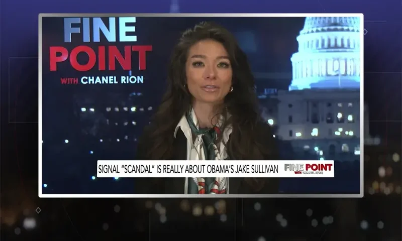 Video still of the host of Fine Point at the desk of their talk show on One America News Network.