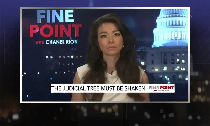 Video still of the host of Fine Point at the desk of their talk show on One America News Network.