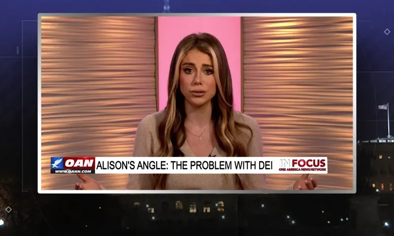 Video still of the host of In Focus at the desk of their talk show on One America News Network.