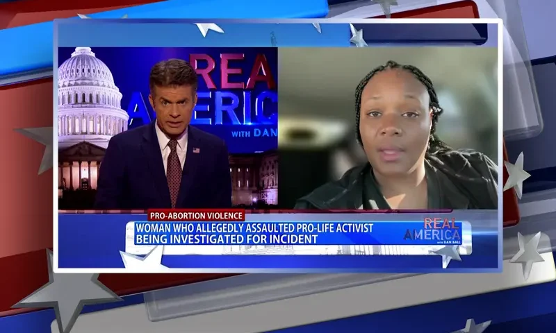 Video still from Real America on One America News Network showing a split screen of the host on the left side, and on the right side is the guest, Bevelyn Williams.