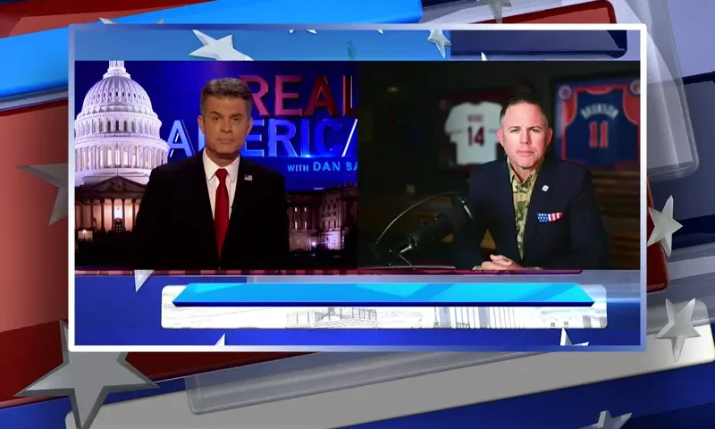 Video still from Real America on One America News Network showing a split screen of the host on the left side, and on the right side is the guest, John Rourke.