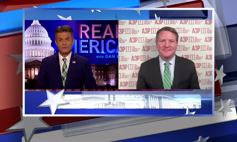 Video still from Real America on One America News Network showing a split screen of the host on the left side, and on the right side is the guest, Mike Davis.