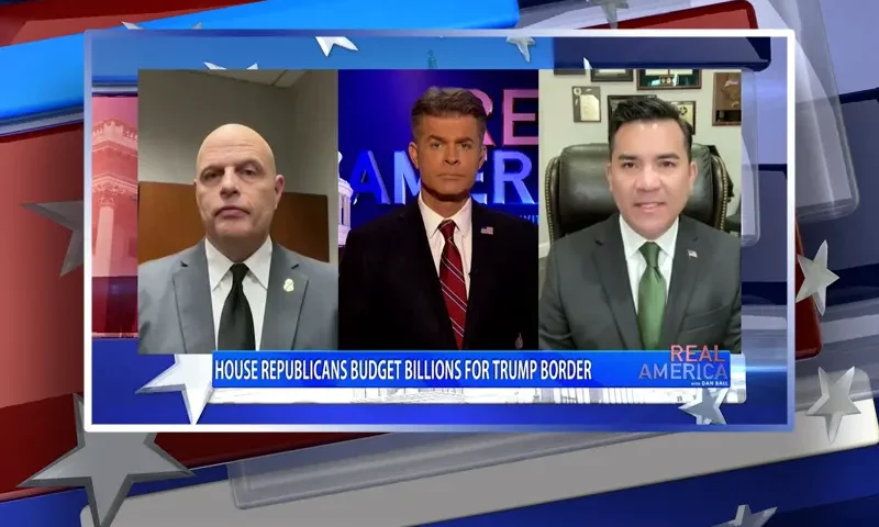 Video still from Real America on One America News Network during an interview with the guests Victor Avila and Ron Vitiello.