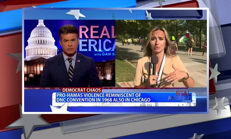 Video still from Real America on One America News Network showing a split screen of the host on the left side, and on the right side is the guest, Monica Paige.