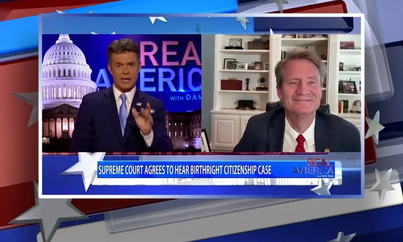 Video still from Real America on One America News Network showing a split screen of the host on the left side, and on the right side is the guest, Tim Burchett.