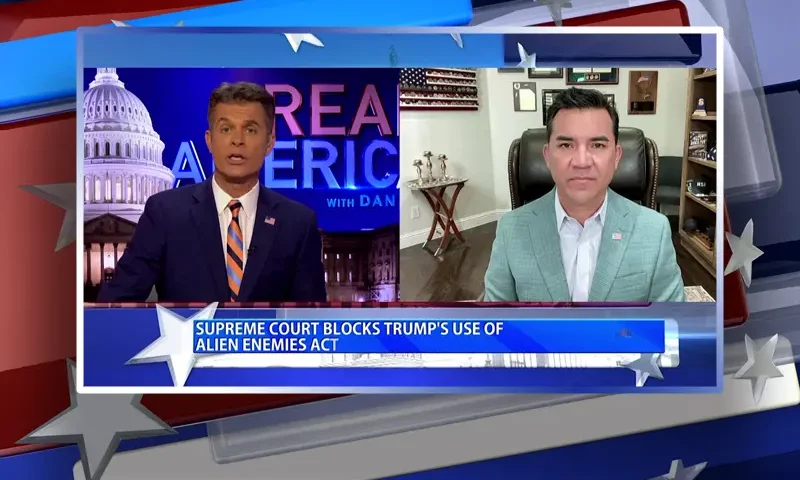 Video still from Real America on One America News Network showing a split screen of the host on the left side, and on the right side is the guest, Victor Avila.