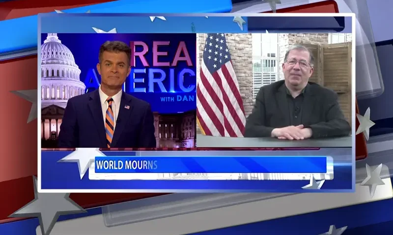 Video still from Real America on One America News Network showing a split screen of the host on the left side, and on the right side is the guest, Frank Pavone.