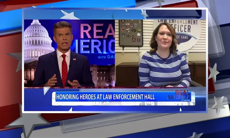 Video still from Real America on One America News Network showing a split screen of the host on the left side, and on the right side is the guest, Megan Stockburger.