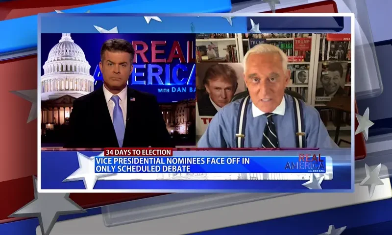Video still from Real America on One America News Network showing a split screen of the host on the left side, and on the right side is the guest, Roger Stone.