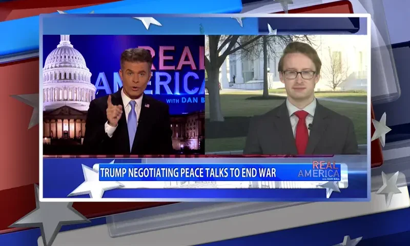 Video still from Real America on One America News Network showing a split screen of the host on the left side, and on the right side is the guest, Daniel Baldwin.