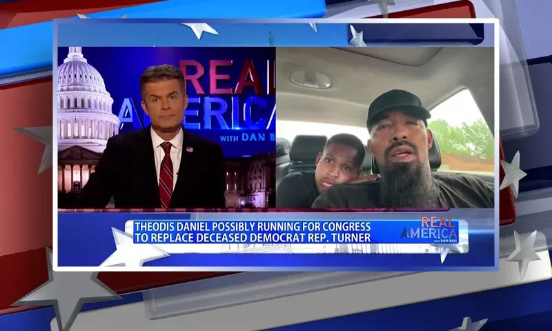 Video still from Real America on One America News Network showing a split screen of the host on the left side, and on the right side is the guest, Theodis Daniel.