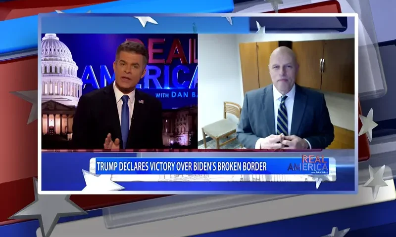 Video still from Real America on One America News Network showing a split screen of the host on the left side, and on the right side is the guest, Ron Vitiello.