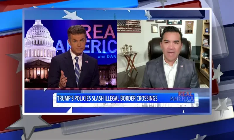 Video still from Real America on One America News Network showing a split screen of the host on the left side, and on the right side is the guest, Victor Avila.