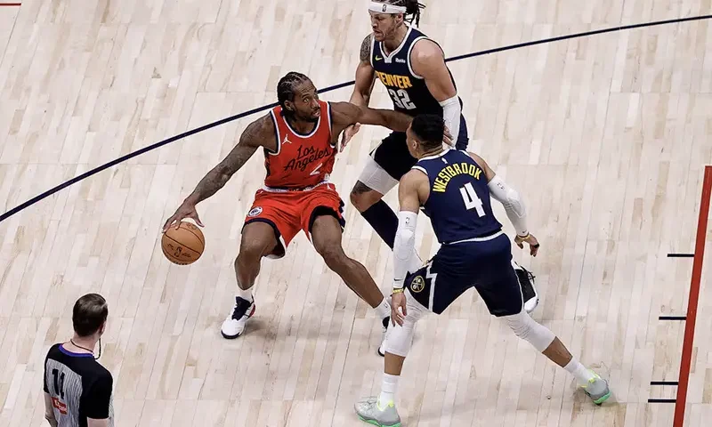 Los Angeles Clippers forward Kawhi Leonard (2) controls the ball as Denver Nuggets forward Aaron Gordon (32) and guard Russell Westbrook (4) guards in the fourth quarter during game two of first round for the 2025 NBA Playoffs at Ball Arena. Mandatory Credit: Isaiah J. Downing-Imagn Images