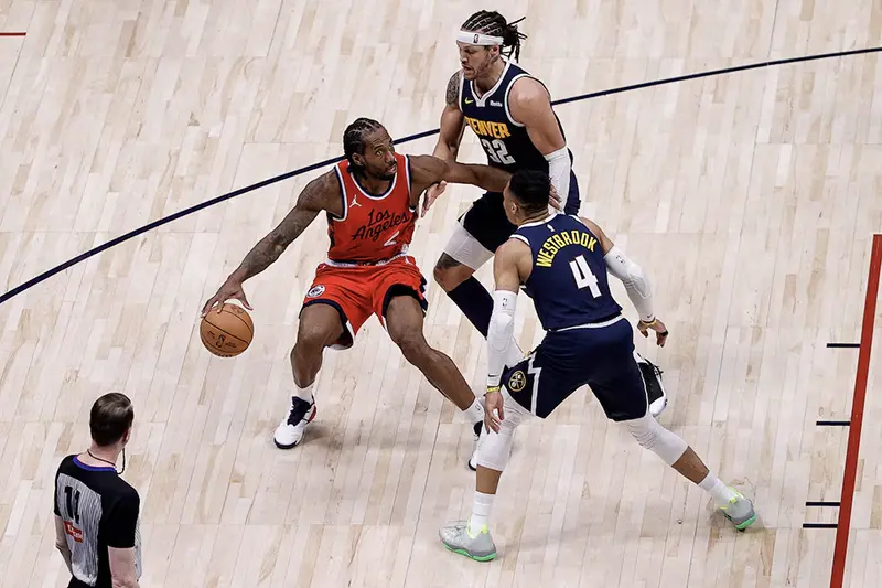 Los Angeles Clippers forward Kawhi Leonard (2) controls the ball as Denver Nuggets forward Aaron Gordon (32) and guard Russell Westbrook (4) guards in the fourth quarter during game two of first round for the 2025 NBA Playoffs at Ball Arena. Mandatory Credit: Isaiah J. Downing-Imagn Images