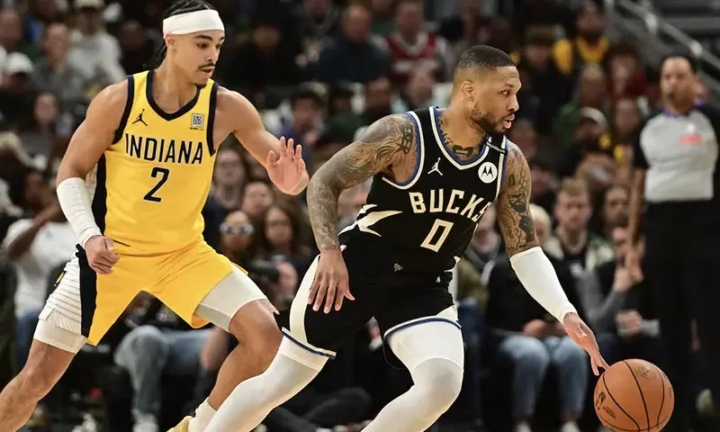 Milwaukee Bucks guard Damian Lillard (0) drives for the basket against Indiana Pacers guard Andrew Nembhard (2) in the first quarter during game four of first round for the 2024 NBA Playoffs at Fiserv Forum. Lillard left the game early in the in the first quarter with an injury. Mandatory Credit: Benny Sieu-Imagn Images