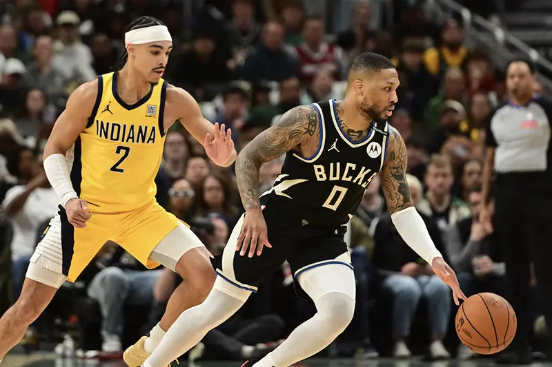 Milwaukee Bucks guard Damian Lillard (0) drives for the basket against Indiana Pacers guard Andrew Nembhard (2) in the first quarter during game four of first round for the 2024 NBA Playoffs at Fiserv Forum. Lillard left the game early in the in the first quarter with an injury. Mandatory Credit: Benny Sieu-Imagn Images